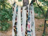 a dream catcher with long fringe of colorful fabric can eb made by you yourself to decorate the wedding venue