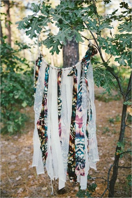 A dream catcher with long fringe of colorful fabric can eb made by you yourself to decorate the wedding venue