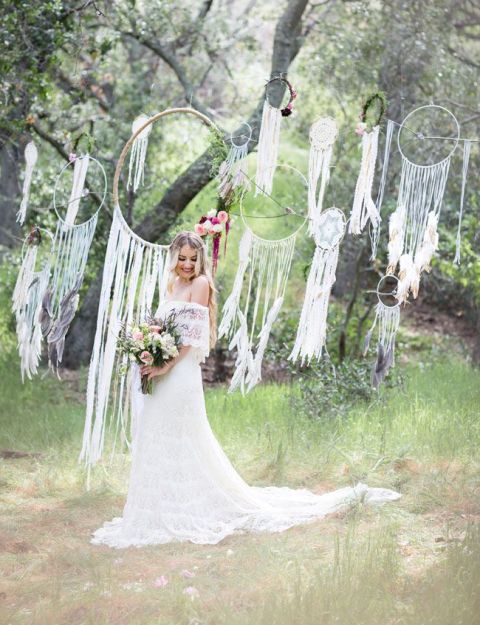 A wedding backdrop of many dreamcatchers with long fringe is a truly boho idea to go for