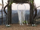 a large wedding arch of moss, branches and with a large dream catcher with long fringe is a cool idea