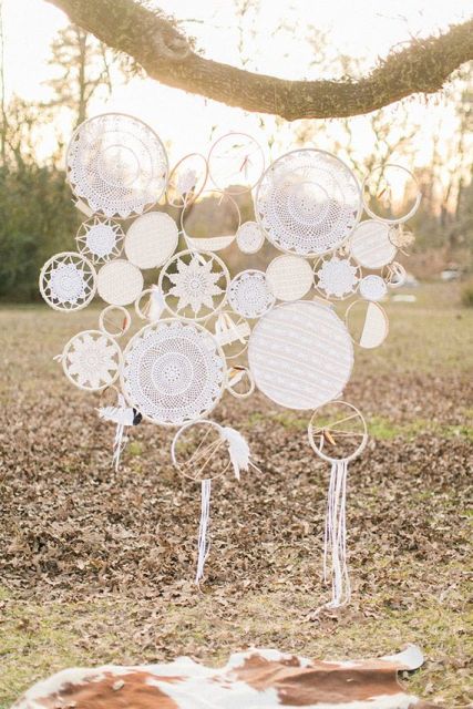 A chic wedding backdrop of multiple crochet dreamcatchers attached to each other for a chic and bold look
