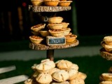a rustic pie stand of wood slices and with chalkboard marks plus delicious pies of all kinds