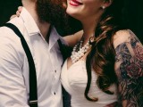 a white cuffed sleeve shirt showing off the groom’s arm tattoos is a lovely idea to show off the tattoos