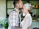 a vintage rustic groom’s look with a plaid shirt and black suspenders, cuffed sleeves showing off the tattoos of the grooms