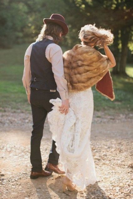 a vintage groom's look with a black waistcoat, pants, a neutral shirt, a brown hat and brown shoes