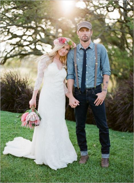 a rustic groom's look with navy jeans, brown shoes and a chambray shirt, suspenders and a cap