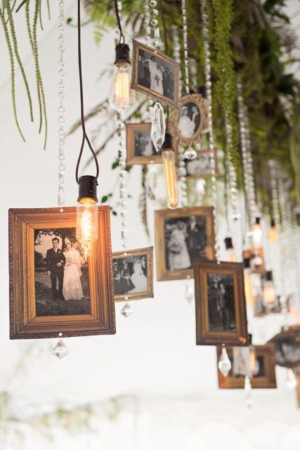 family photos, crystals, bulbs and greenery hanging down from the holder is a fun idea