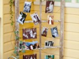 a rustic shabby chic window frame with greenery and family photos is a cozy substitute for a family tree
