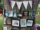 a real tree with a bunting and lots of family photos in colorful frames is a stylish and fun idea for an outdoor wedding