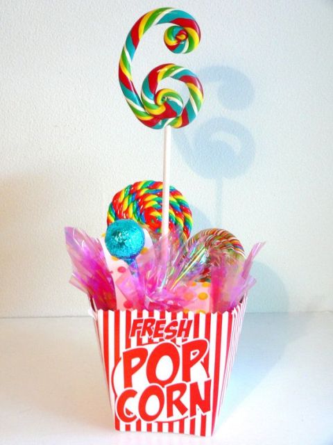 a colorful table number of a bold box, colorful lollipops and a lollipop table number is a lovely idea for a wedding table with a touch of fun