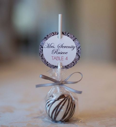 show off escort cards with cake pops or lollipops to make looking for a table tastier and more pleasant