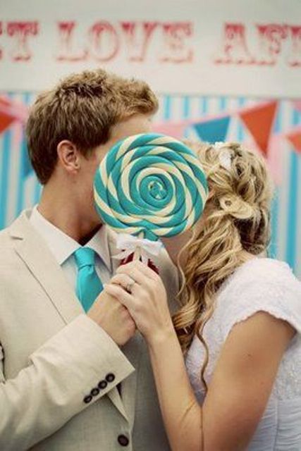 a large turquoise and white swirl lollipop as a fun prop for your wedding portraits or as a wedding bouquet