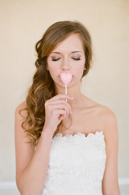 a pink heart shaped lollipop is a lovely wedding favor or a dessert for your wedding dessert table