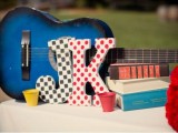 a bright blue guitar and bright monograms is a cool and fun decoration for a wedding
