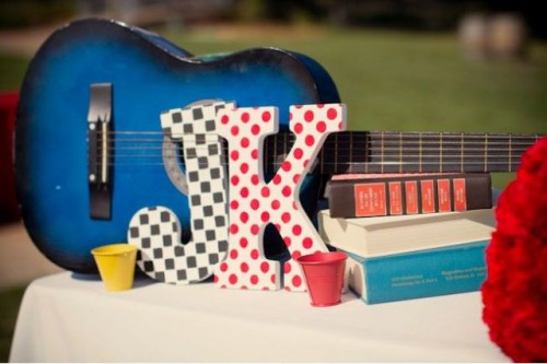 a bright blue guitar and bright monograms is a cool and fun decoration for a wedding