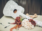 a white guitar as a wedding guest book is a lovely and unique idea thta can be used as decor after the wedding