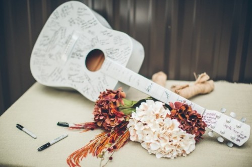 a white guitar as a wedding guest book is a lovely and unique idea thta can be used as decor after the wedding