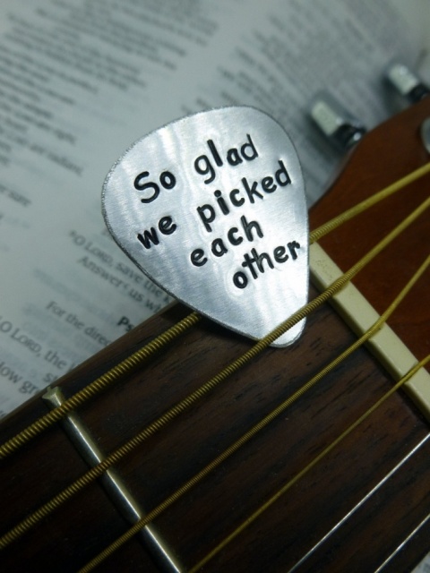 a flat pick with an engraving is a cool wedding favor idea that won't cost too much