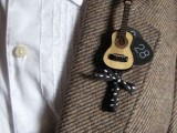 a pretty guitar boutonniere with a polka dot bow is a cool accessory that brings interest to your look