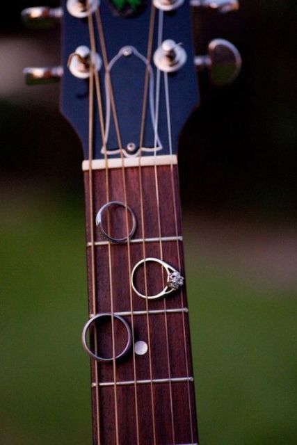show off your wedding rings on a guitar to feature your interests