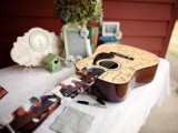 a guitar with photos as a wedding guest book is a very functional and cool idea for a wedding