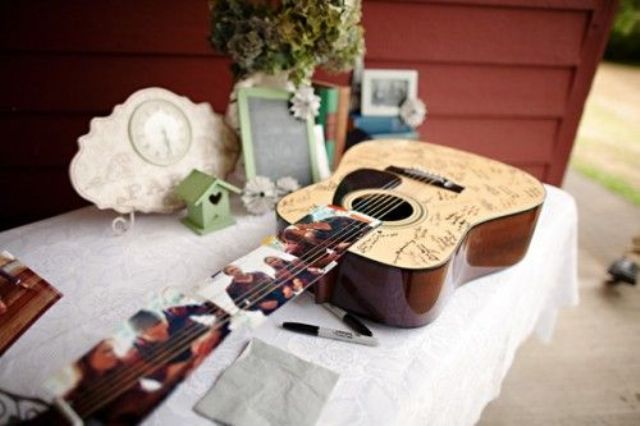 A guitar with photos as a wedding guest book is a very functional and cool idea for a wedding