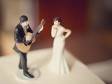 cool wedding cake toppers – a groom playing the guitar and a bride is a very whimsical idea