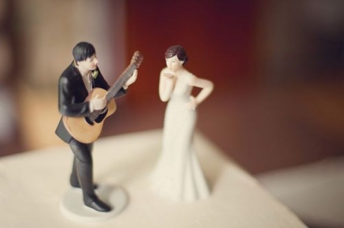 cool wedding cake toppers - a groom playing the guitar and a bride is a very whimsical idea