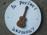 a sign with a wooden guitar is a cool and easy decoration for your wedding venue