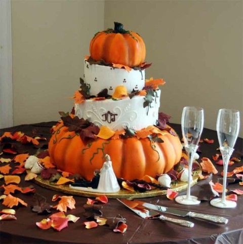 a fall wedding cake with white buttercream and pumpkin tiers, with fall leaves and calligrpahy is a gorgeous rustic wedding idea