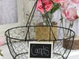 a vintage wire basket with a chalkboard sign is a cool idea for gathering cards and will do for a rustic wedding