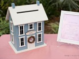 a small blue house with white window frames is a stylish and catchy idea for a quirky wedding, it can become part of decor in your home