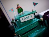 a tiered green card box with little flags and figurines is a cool solution for a geeky wedding