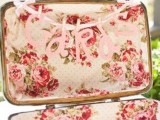 a vintage suitcase with bright floral lining is a cool idea for a vintage wedding and a letter banner explains what to do