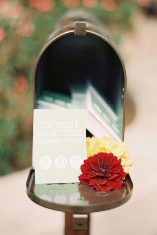 a traditional mail box with bright blooms is a very creative idea of a wedding card box that won't require much effort to put up