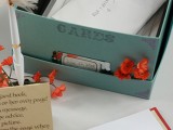 a simple box with a lid, with a tag and some bright blooms is a cool last minute solution if you forgot about wedding card boxes