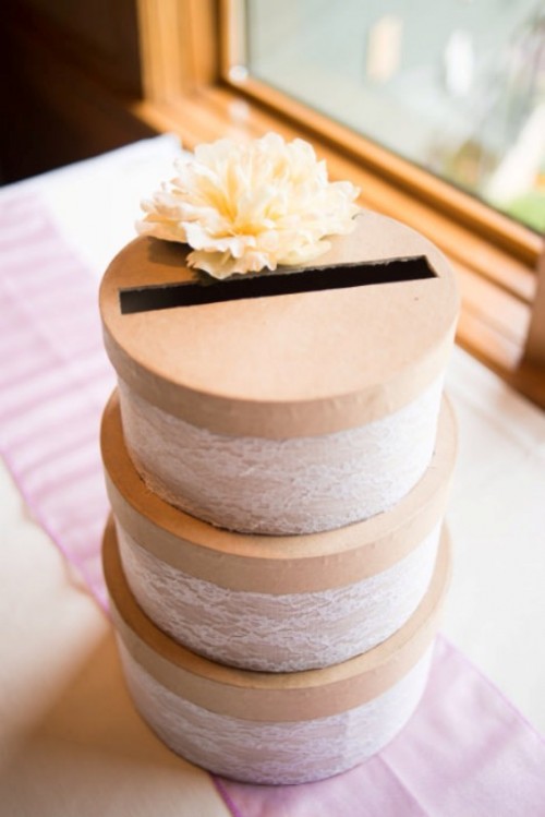 tiered round boxes with lids and lace wrap plus a white bloom on top is a cool and fresh solution for a vintage or just refined wedding