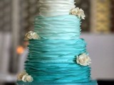 an ombre and textural tiffany blue wedding cake decorated with neutral fresh blooms is a bold and statement-like idea