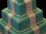 a tiffany blue wedding cake imitating a gift box from tiffany with white ribbons and a large sugar bow on top is a creative idea