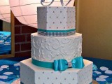 a white patterned wedding cake with edible beads and patterns plus tiffany blue decor – ribbons and bows