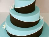 an elegant chocolate brown and blue wedding cake with white orchids is a stylish idea with a contrast