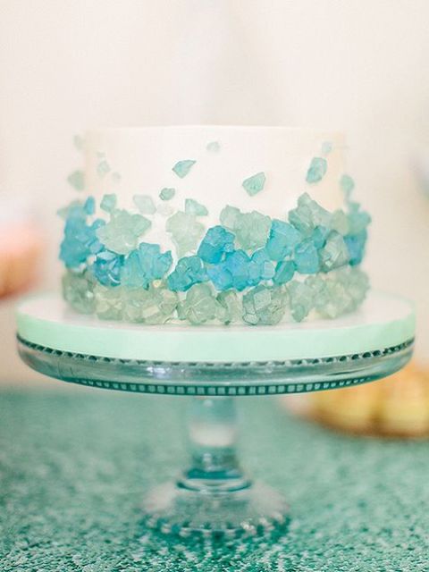 a white wedding cake decorated with aqua and tiffany blue edible sea glass is a great idea for a coastal wedding