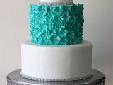 a chic white and tiffany blue wedding cake with sleek tiers, a floral tier and some embellishments