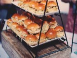 a wooden box with a black metal stand with lots of burgers will help you save some space and will make your guests happy