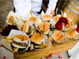 a wooden box with burgers in simple paper cones to make them more individual and easier to serve