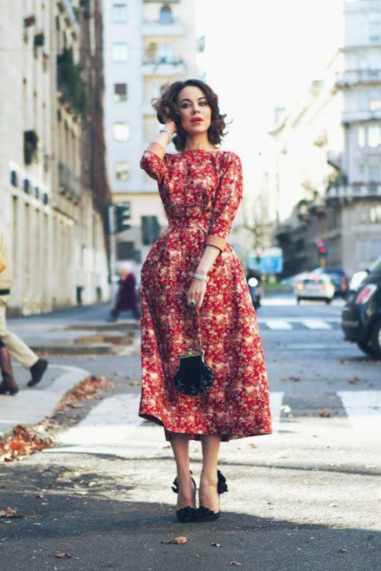 A red floral midi dress with an A line silhouette, black shoes and a black bag is a trendy idea   florals are a hot idea