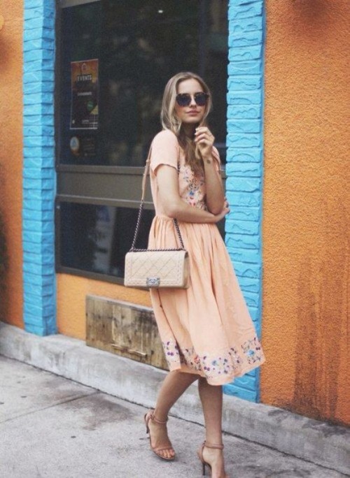 a blush midi dress with floral embroidery in blue, nude shoes and a nude bag for a spring wedding