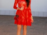 a red lace mini dress with a high neckline and long sleeves, metallic shoes and a mini red bag
