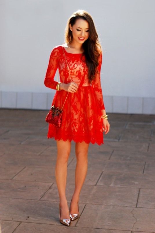 A red lace mini dress with a high neckline and long sleeves, metallic shoes and a mini red bag