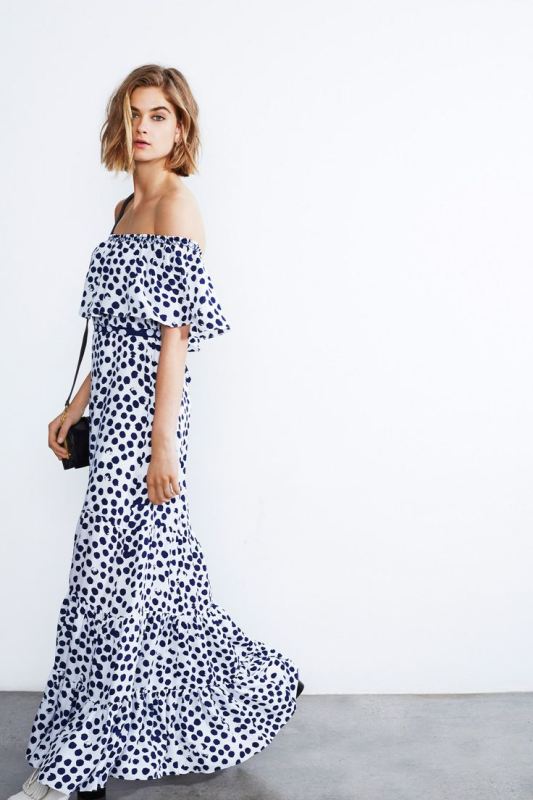 An off the shoulder black and white polka dot maxi dress, a black bag is classic monochrome for a modern spring wedding